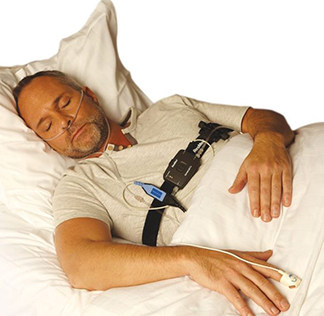 Man sleeping with test device in place