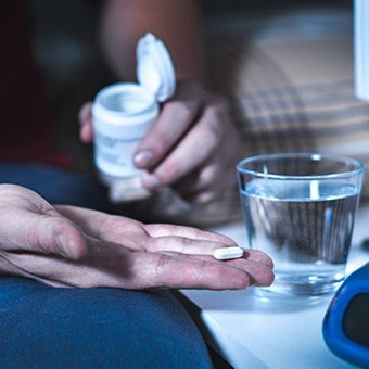 Hand holding a pill