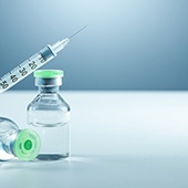 A syringe and two insulin bottles