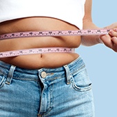 A person using a tape measure around their waist
