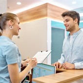 Man discussing payment with a staff member    