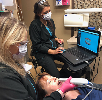 Dr. Shults using Carestream scanner