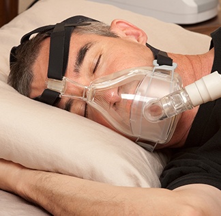 Man sleeping with CPAP system