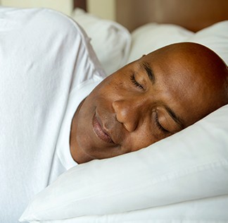 Man sleeping soundly in bed