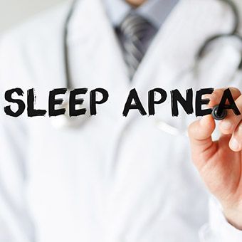 Person in lab coat writing sleep apnea