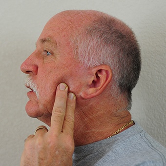 Man doing TMJ exercises