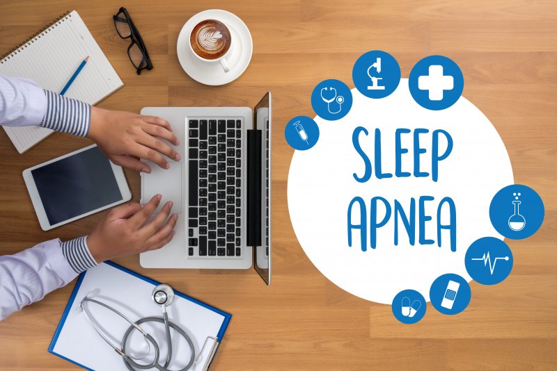 a person on the computer with an image reading “Sleep Apnea” nearby