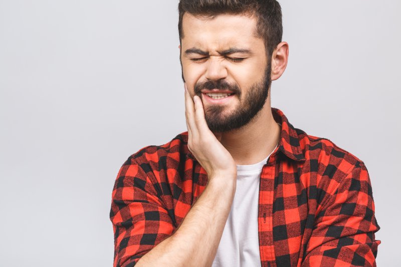 man dealing with TMJ pain 
