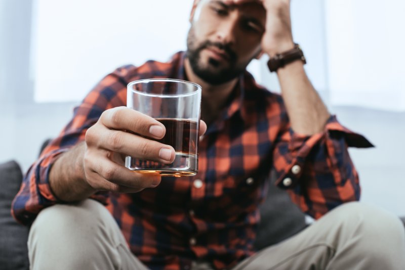 man with a glass of alcohol